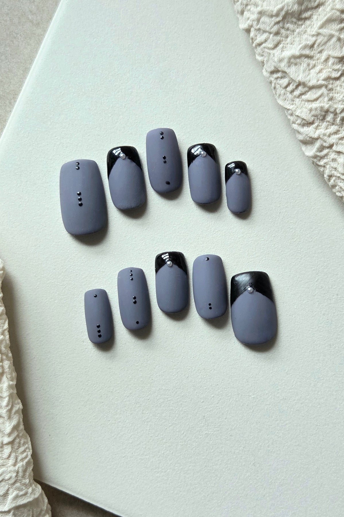 After Midnight matte blue-grey press-on nails with glossy black French tips and crystal details
