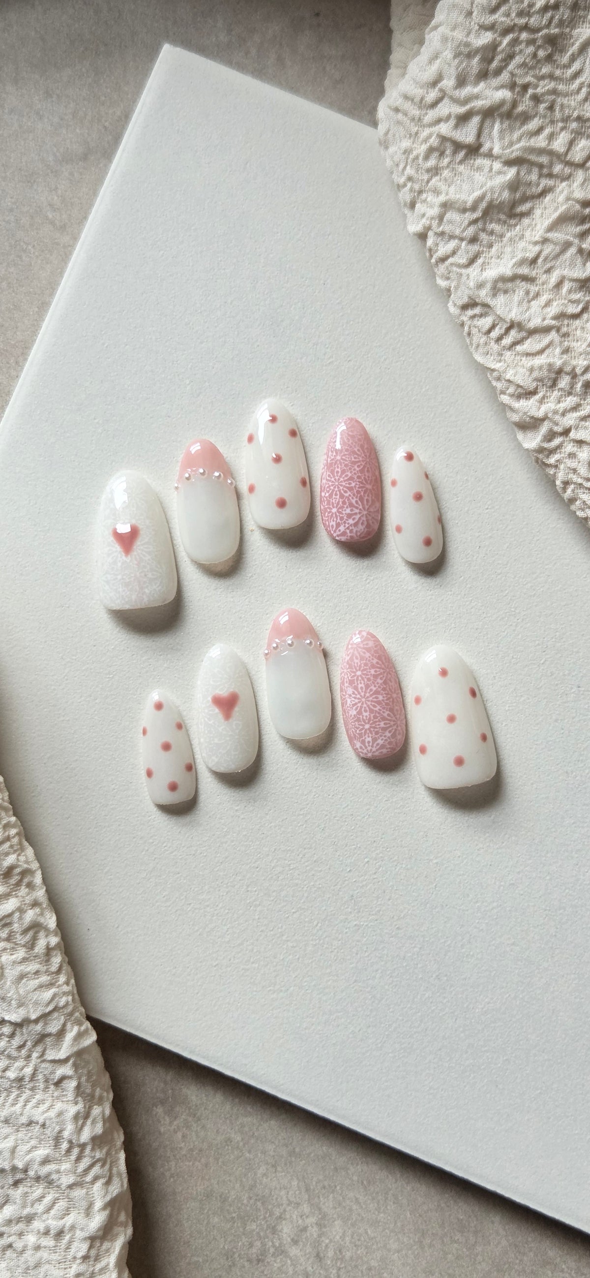 Blush & Lace pink and white hand-painted press-on nails with hearts, lace and pearl details