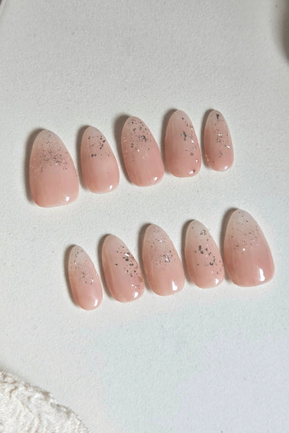 Soft blush pink press-on nails with delicate silver foil and subtle sparkle. Handmade, reusable and available in your choice of shape and size.