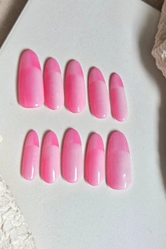 Bright pink and soft blush press-on nails with a modern colour-block design. Handmade, reusable and available in your choice of shape and size.